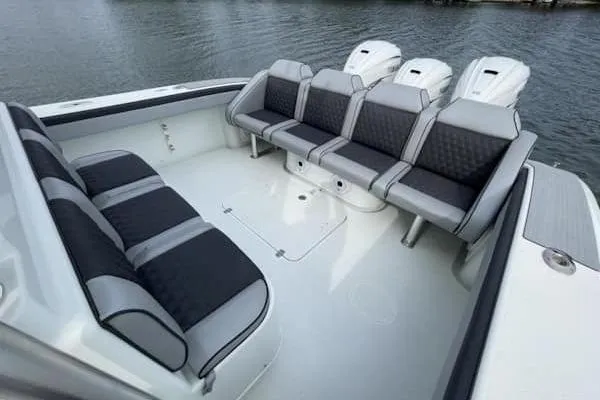 Slide: The Image of 2012 Yellowfin 42 Offshore boat with spacious seating and triple outboard engines. - 15