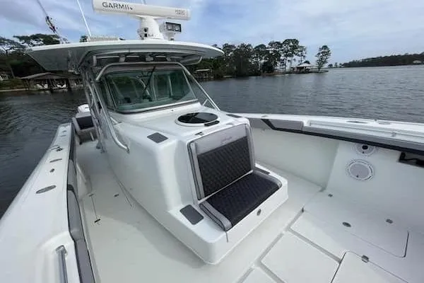 Slide: The Image of 2012 Yellowfin 42 Offshore boat on calm water, featuring spacious deck and advanced navigation equipment. - 16