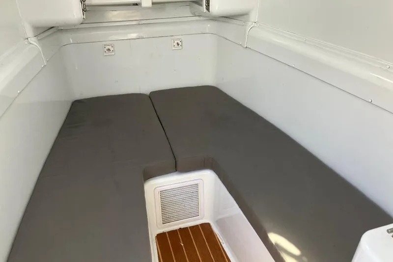 Slide: The Image of Interior cabin of 2012 Yellowfin 42 Offshore boat with cushioned seating. - 21