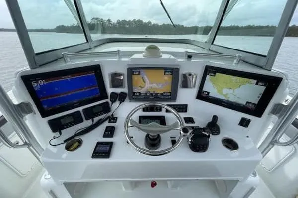 Slide: The Image of 2012 Yellowfin 42 Offshore boat dashboard with navigation screens and controls. - 5