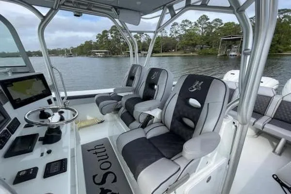 Slide: The Image of 2012 Yellowfin 42 Offshore boat interior with modern seating and navigation equipment. - 6