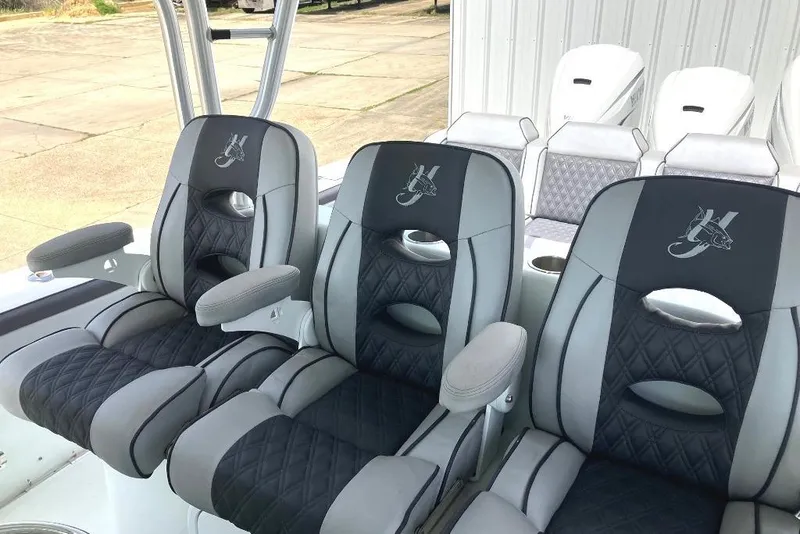 Slide: The Image of Luxurious seating on a 2012 Yellowfin 42 Offshore boat, featuring stylish black and gray upholstery. - 7