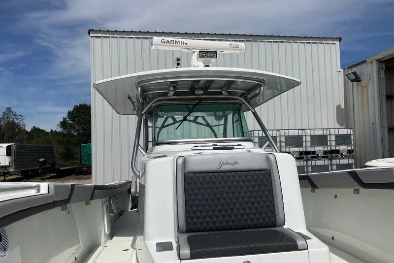 Slide: The Image of 2012 Yellowfin 42 Offshore boat with Garmin radar, docked near a warehouse. - 8