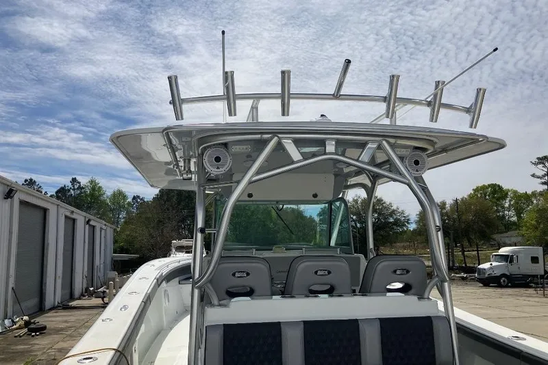 Slide: The Image of 2012 Yellowfin 42 Offshore boat with rod holders and seating, docked outdoors. - 9