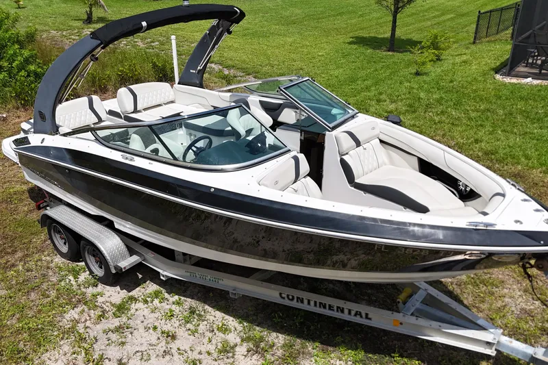 The Image of 2018 Regal 2300 Bowrider boat on trailer, parked on grass. - 0