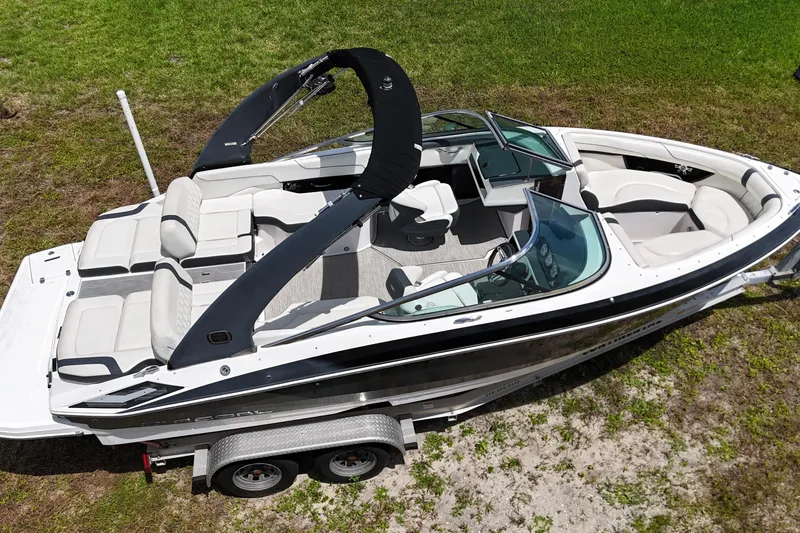 Slide: The Image of 2018 Regal 2300 Bowrider boat on trailer, featuring sleek design and spacious seating. - 5