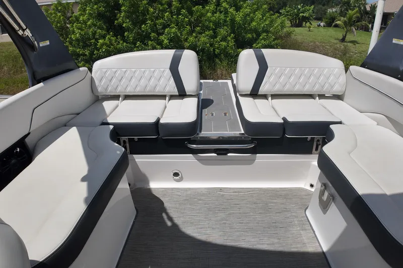Slide: The Image of 2018 Regal 2300 Bowrider interior with white cushioned seating and sleek design. - 9