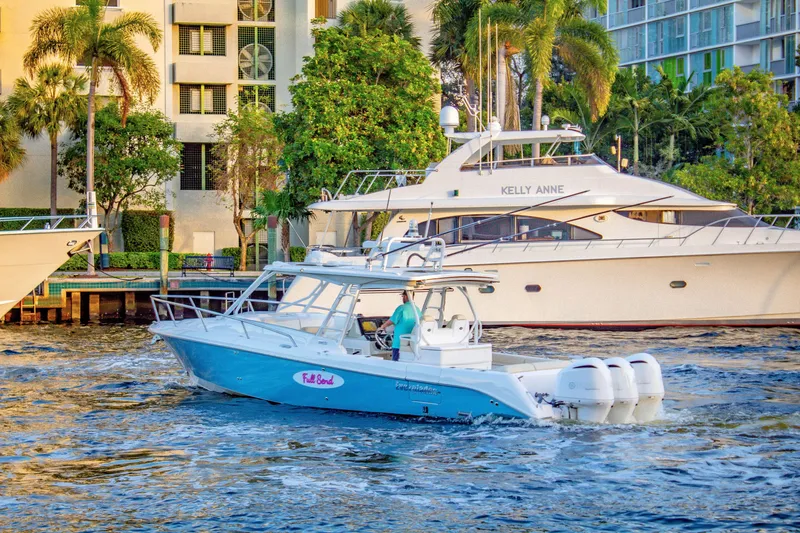 Slide: The Image of 2017 Everglades 360 LXC boat cruising near waterfront buildings and yachts. - 0