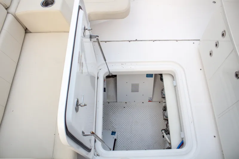 Slide: The Image of Open hatch on 2017 Everglades 360 LXC boat, revealing interior compartment. - 10