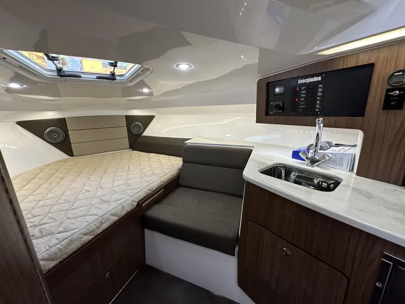 Slide: The Image of Interior of 2017 Everglades 360 LXC boat with bed, seating, and kitchenette. - 24