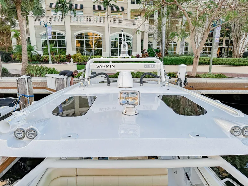 Slide: The Image of 2017 Everglades 360 LXC boat docked, featuring Garmin radar and sleek design. - 29