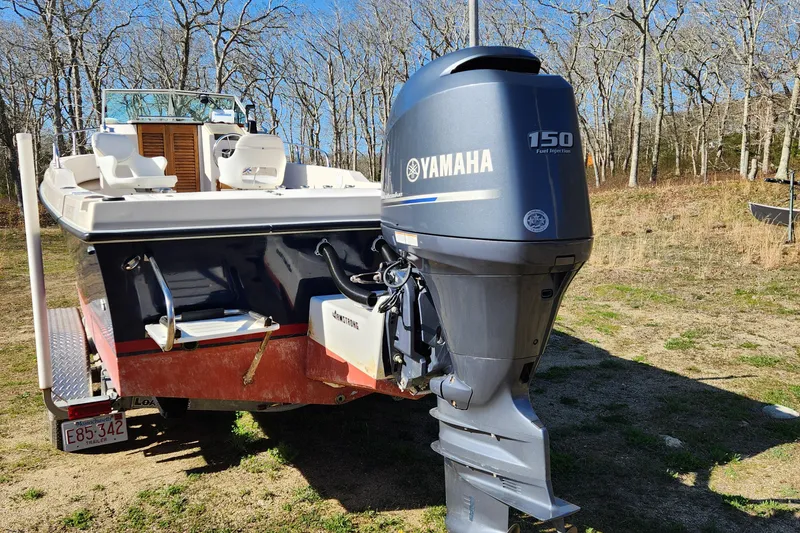 Slide: The Image of 1985 Sea Ox 23 boat with Yamaha 150 outboard motor, parked outdoors. - 3