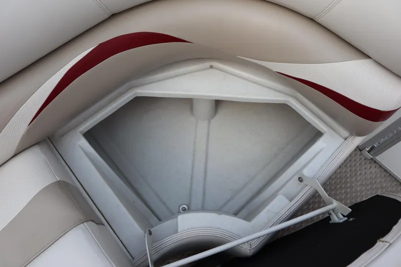 Slide: The Image of Storage compartment in 2005 Crest 25 Caribbean boat with beige and red seating. - 14