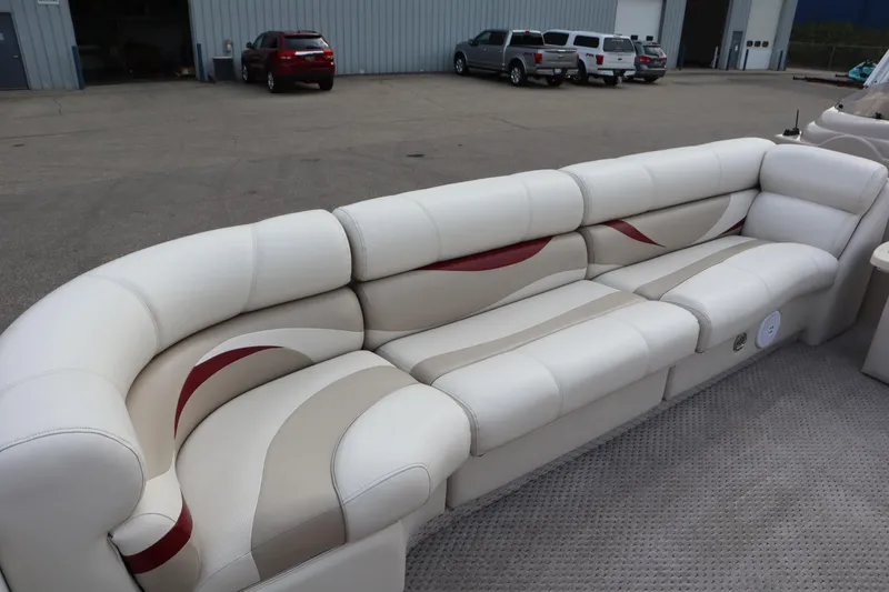 Slide: The Image of 2005 Crest 25 Caribbean boat interior with white and beige seating, parked in a lot. - 15