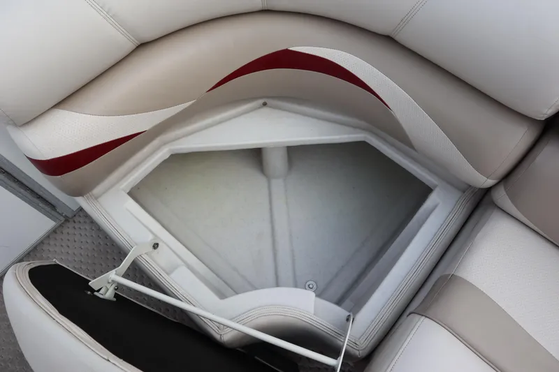 Slide: The Image of Crest 25 Caribbean 2005 boat seat storage compartment with beige and red upholstery. - 16