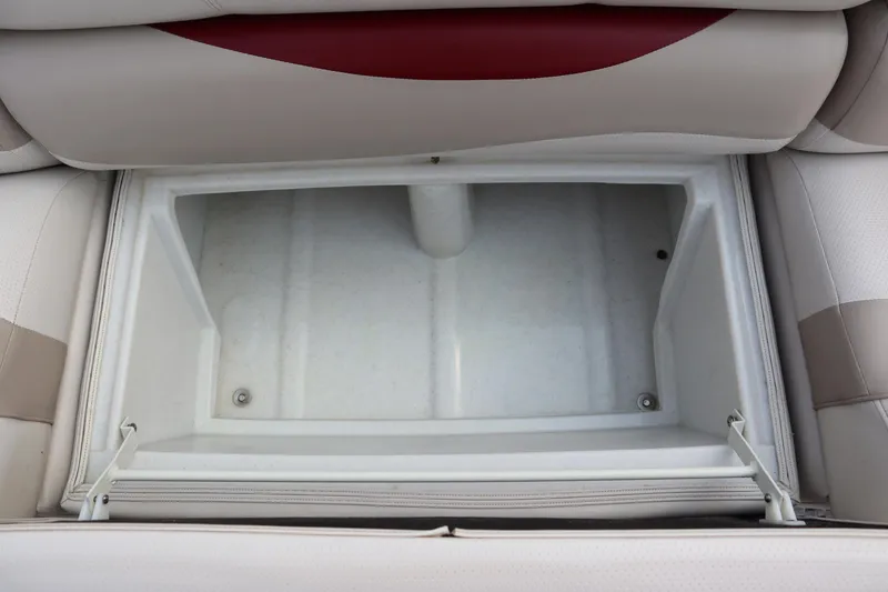 Slide: The Image of Storage compartment in 2005 Crest 25 Caribbean boat, featuring beige and red seating. - 17