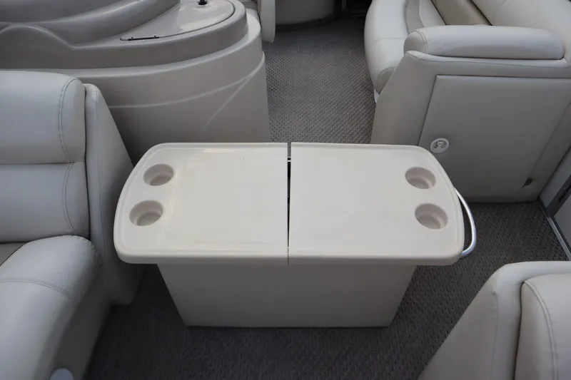 Slide: The Image of Interior of 2005 Crest 25 Caribbean boat with beige seating and table with cup holders. - 19