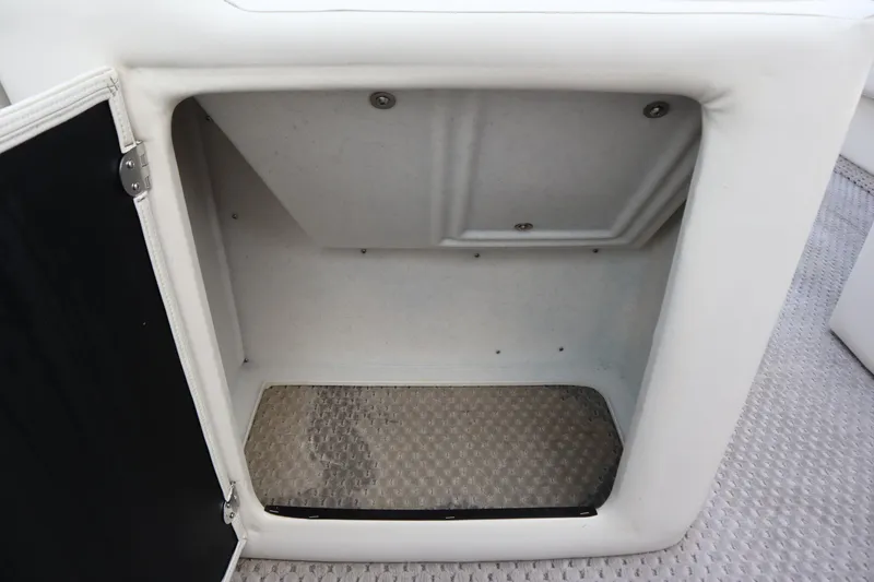 Slide: The Image of Open storage compartment on a 2005 Crest 25 Caribbean boat. - 22