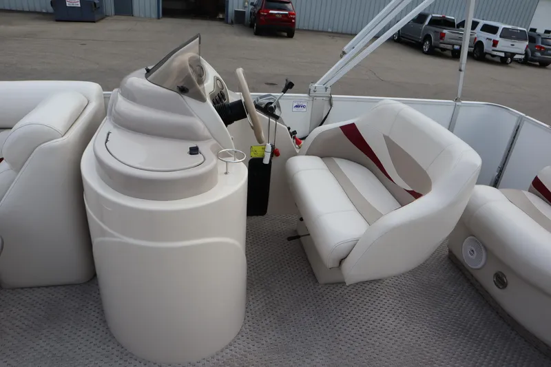Slide: The Image of 2005 Crest 25 Caribbean boat interior with steering console and seating. - 23