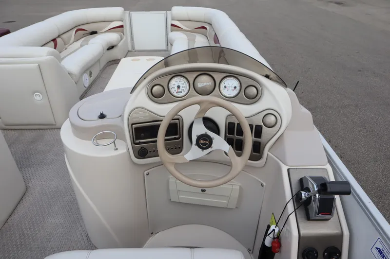 Slide: The Image of Steering console of a 2005 Crest 25 Caribbean boat with beige interior. - 24