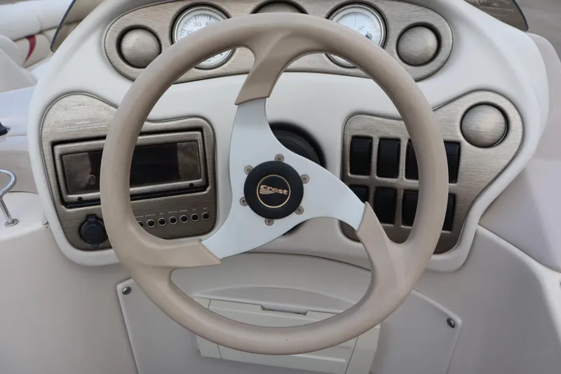 Slide: The Image of Steering wheel and dashboard of a 2005 Crest 25 Caribbean boat. - 25