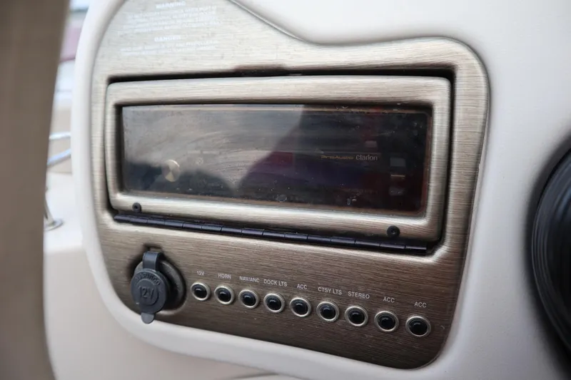 Slide: The Image of Dashboard of a 2005 Crest 25 Caribbean boat featuring a Clarion audio system. - 27