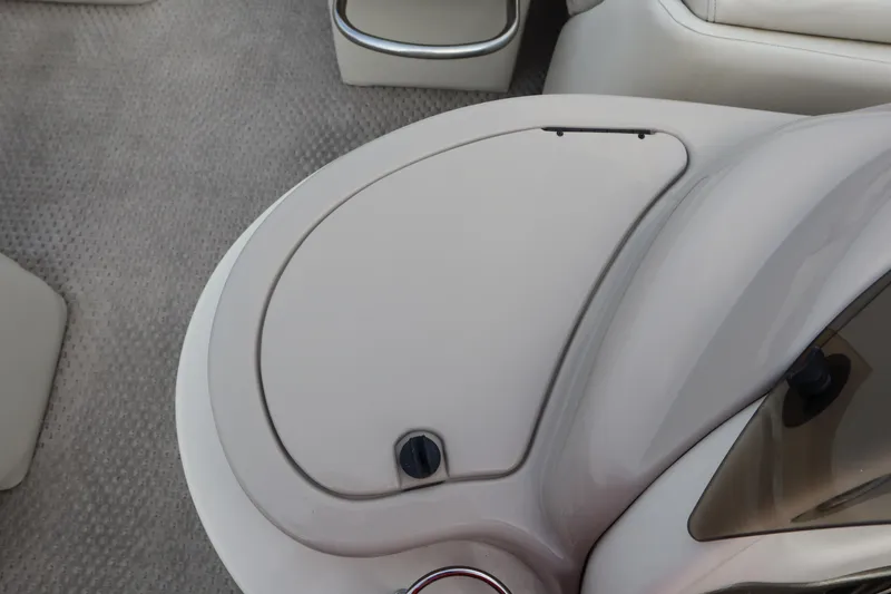 Slide: The Image of 2005 Crest 25 Caribbean boat interior with storage compartment and seating area. - 32