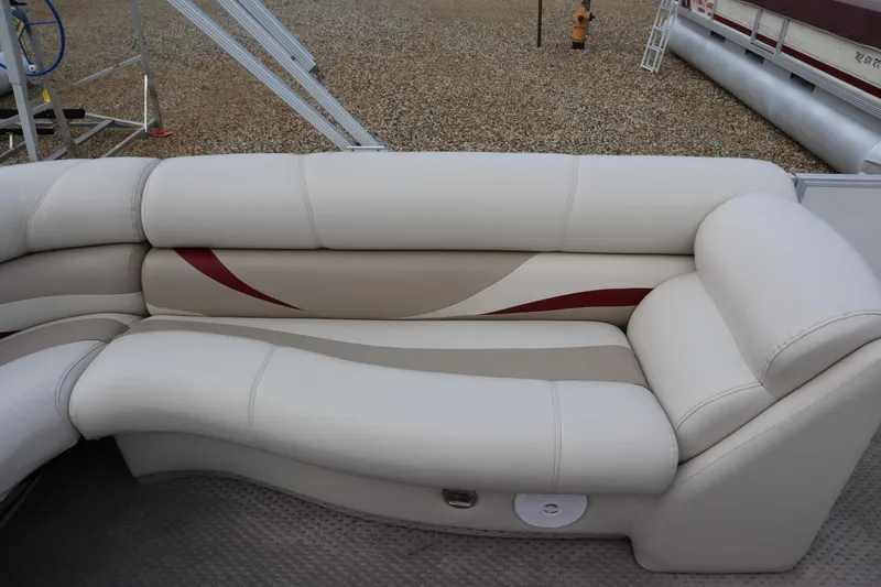 Slide: The Image of 2005 Crest 25 Caribbean boat interior with beige and red cushioned seating. - 38