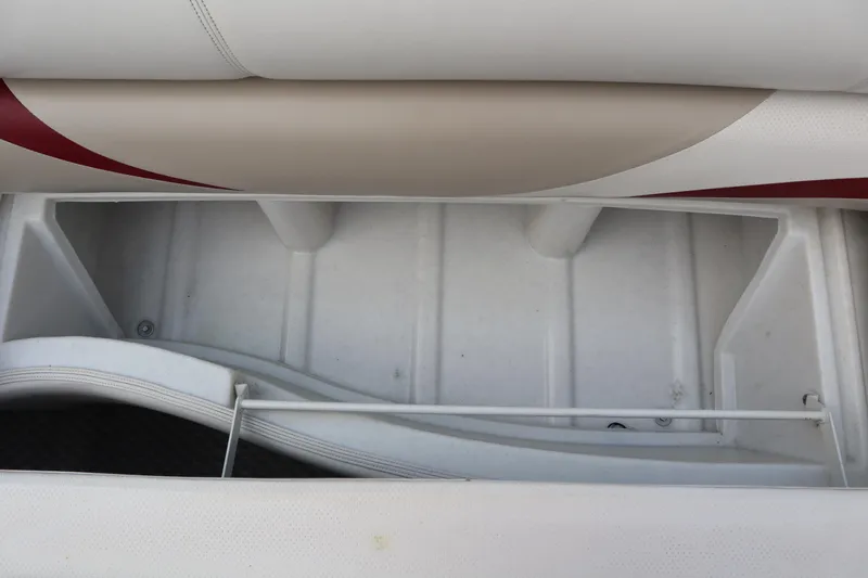 Slide: The Image of Storage compartment of a 2005 Crest 25 Caribbean boat, featuring white and beige seating. - 39