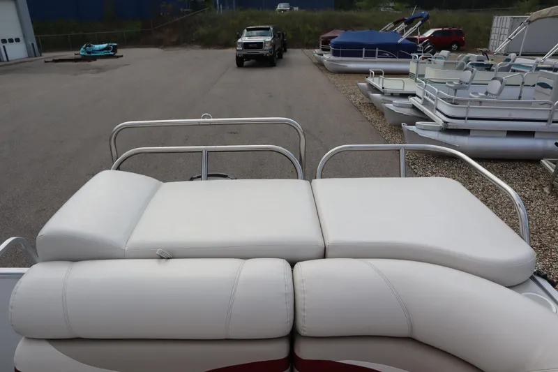 Slide: The Image of 2005 Crest 25 Caribbean boat with white cushioned seating in a marina. - 43