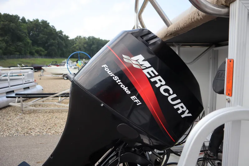 Slide: The Image of Mercury FourStroke EFI engine on a 2005 Crest 25 Caribbean boat, docked with other boats. - 46