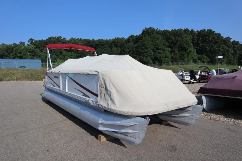 Slide: The Image of Covered 2005 Crest 25 Caribbean pontoon boat in outdoor storage area. - 49