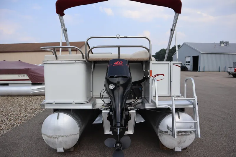 Slide: The Image of 2005 Crest 25 Caribbean pontoon boat with outboard motor, parked outdoors. - 6