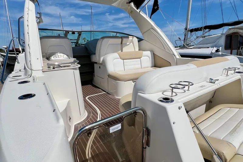 Slide: The Image of 2010 Sea Ray 350 Sundancer yacht interior with white seating and cup holders. - 11