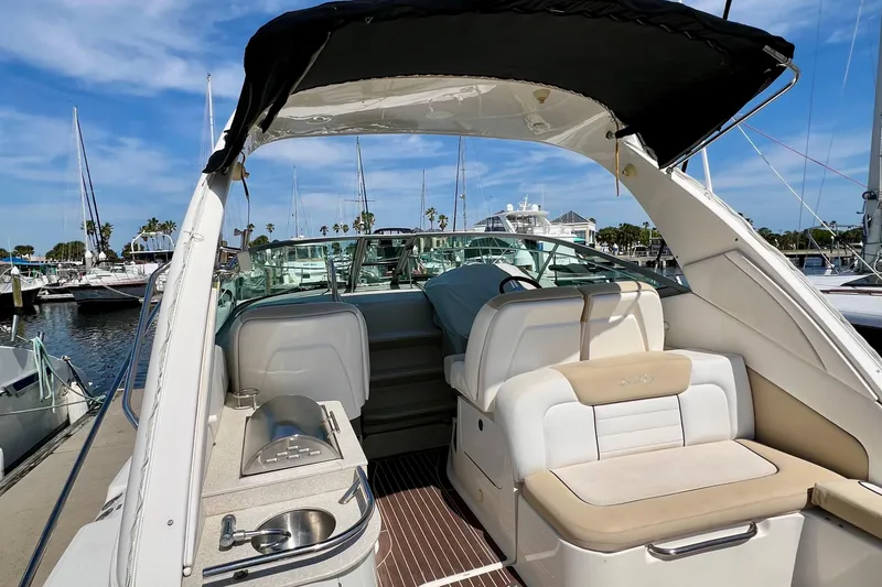 Slide: The Image of 2010 Sea Ray 350 Sundancer yacht interior with seating and kitchenette at marina. - 12