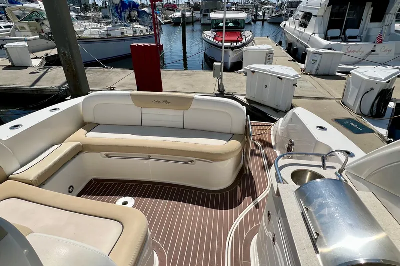 Slide: The Image of 2010 Sea Ray 350 Sundancer yacht interior with seating and dock view. - 18