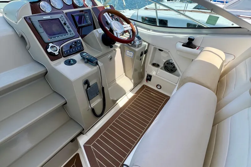 Slide: The Image of Cockpit of 2010 Sea Ray 350 Sundancer with modern controls and seating. - 27
