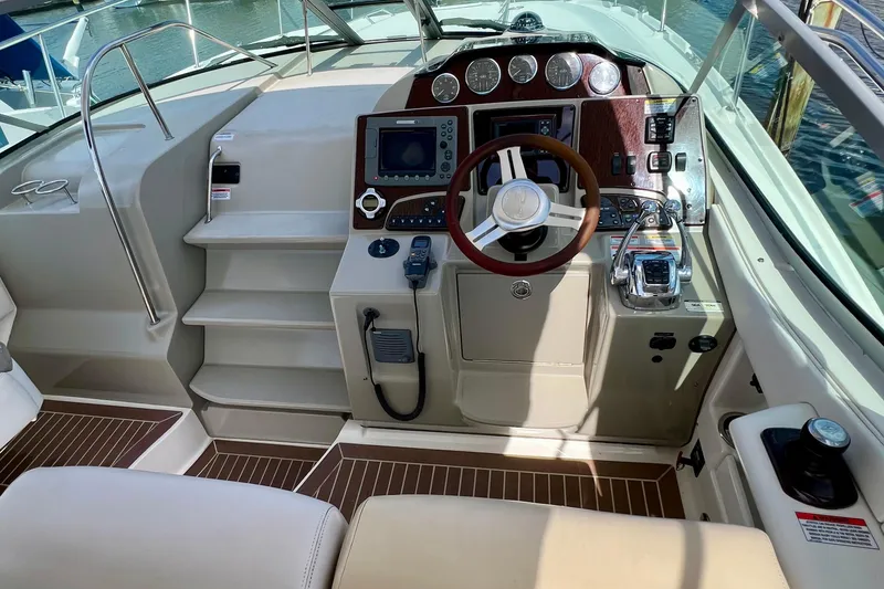 Slide: The Image of Cockpit of 2010 Sea Ray 350 Sundancer with steering wheel and control panel. - 28