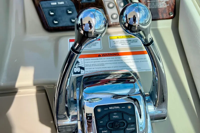 Slide: The Image of Close-up of 2010 Sea Ray 350 Sundancer throttle controls with warning labels. - 30