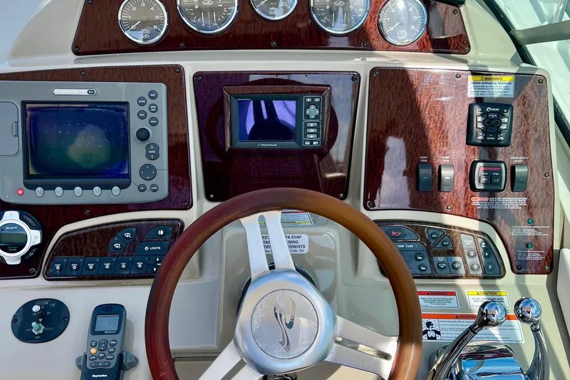 Slide: The Image of Control panel of a 2010 Sea Ray 350 Sundancer boat with navigation instruments. - 32