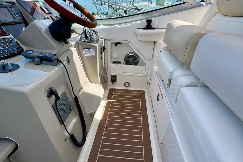 Slide: The Image of Cockpit of 2010 Sea Ray 350 Sundancer with steering wheel and seating area. - 36