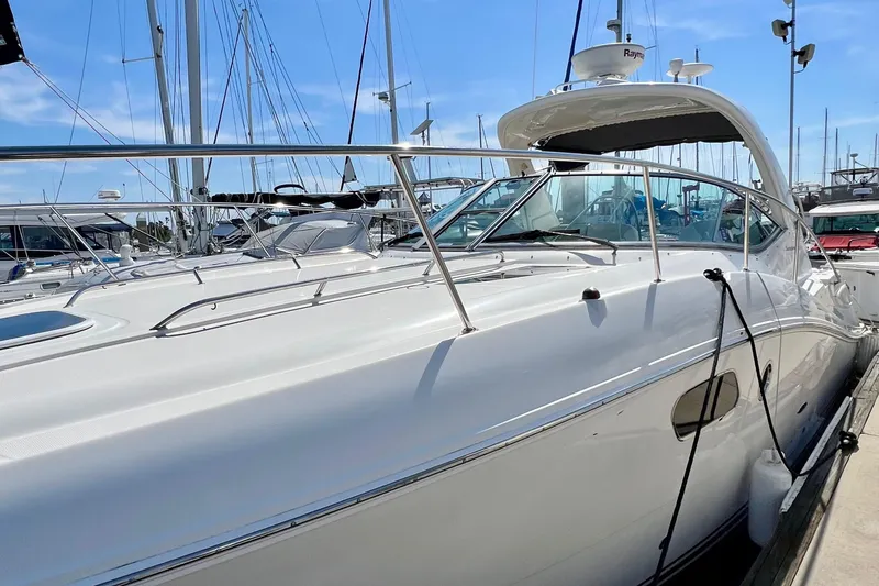 Slide: The Image of 2010 Sea Ray 350 Sundancer yacht docked at marina under clear blue sky. - 4