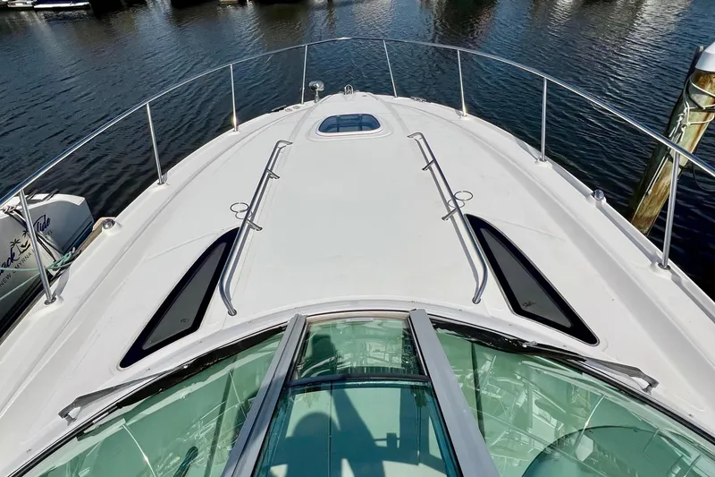 Slide: The Image of Bow view of a 2010 Sea Ray 350 Sundancer yacht on calm water. - 41