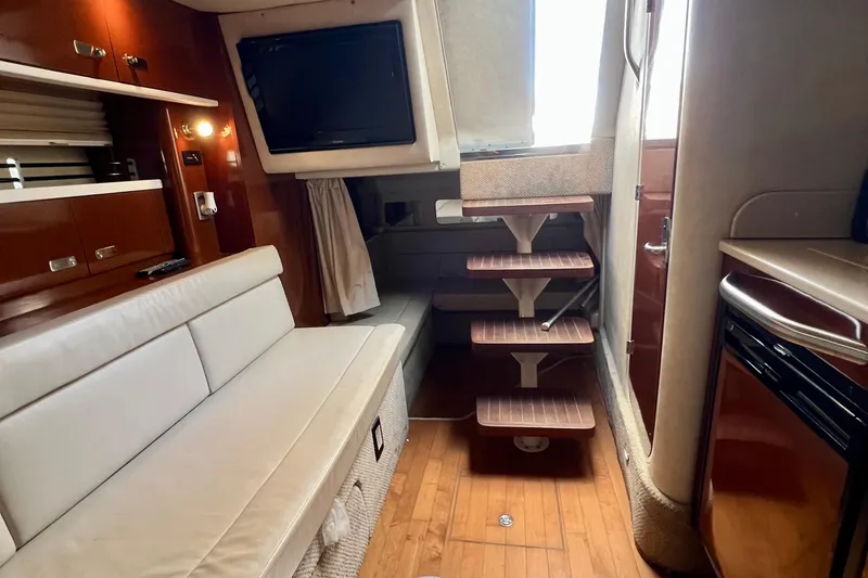Slide: The Image of Interior of 2010 Sea Ray 350 Sundancer yacht with seating, stairs, and cabinetry. - 42