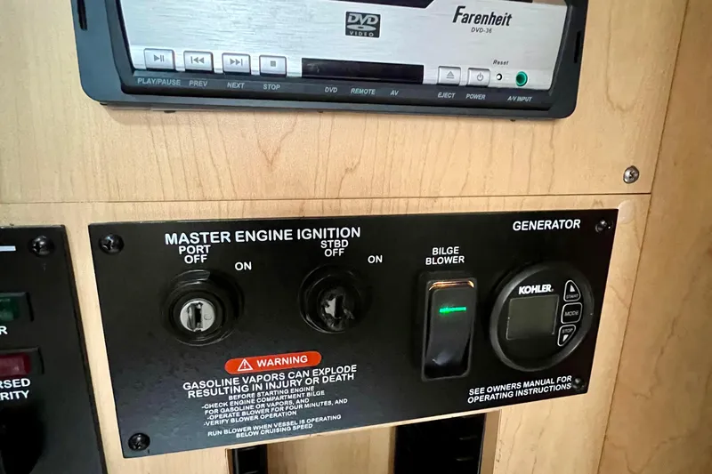 Slide: The Image of Control panel of a 2010 Sea Ray 350 Sundancer with engine ignition and generator switches. - 47