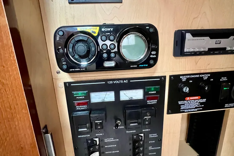 Slide: The Image of Control panel of a 2010 Sea Ray 350 Sundancer boat with audio and power systems. - 48