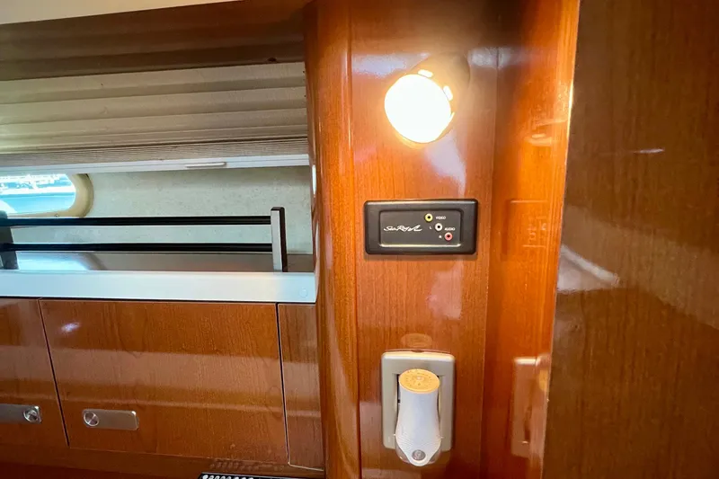 Slide: The Image of Interior of 2010 Sea Ray 350 Sundancer with wood paneling and light fixture. - 49