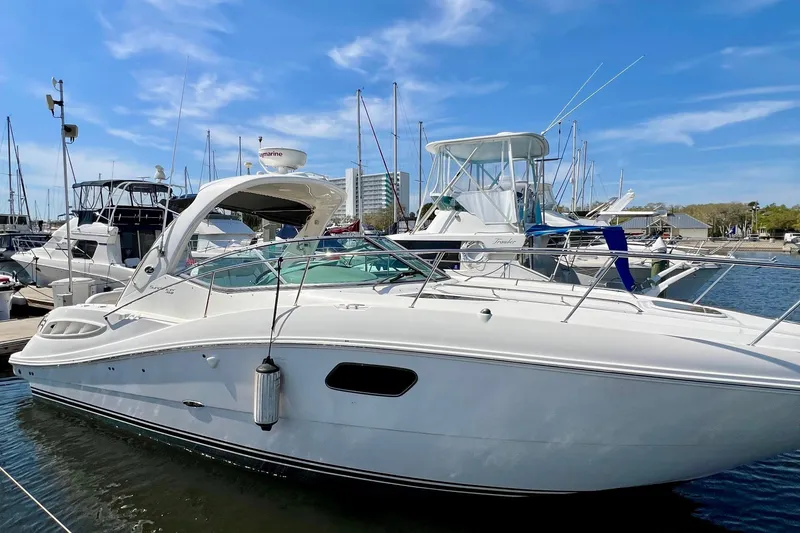 Slide: The Image of 2010 Sea Ray 350 Sundancer yacht docked at marina under clear blue sky. - 5