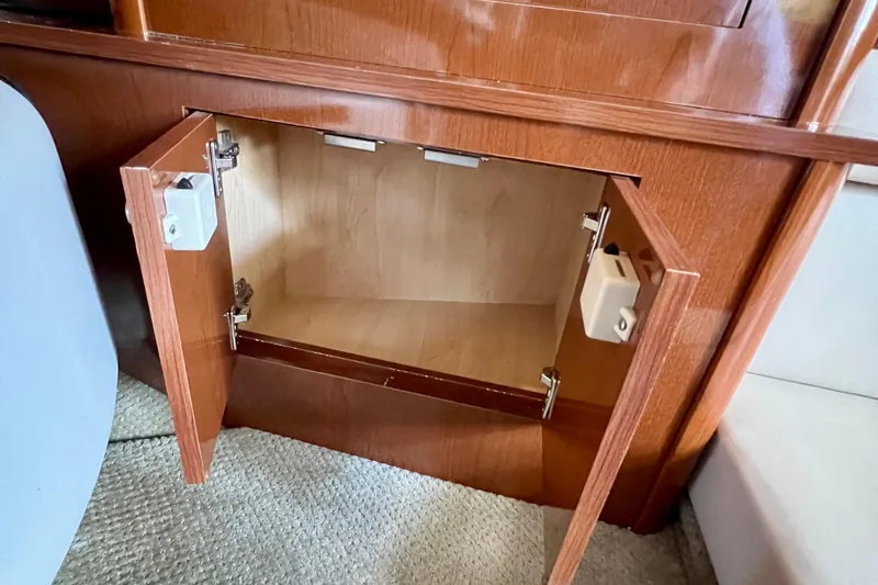 Slide: The Image of Open wooden cabinet on 2010 Sea Ray 350 Sundancer yacht interior. - 53