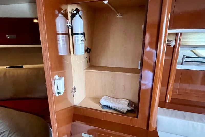 Slide: The Image of Interior of 2010 Sea Ray 350 Sundancer showing wooden cabinet with fire extinguisher. - 54